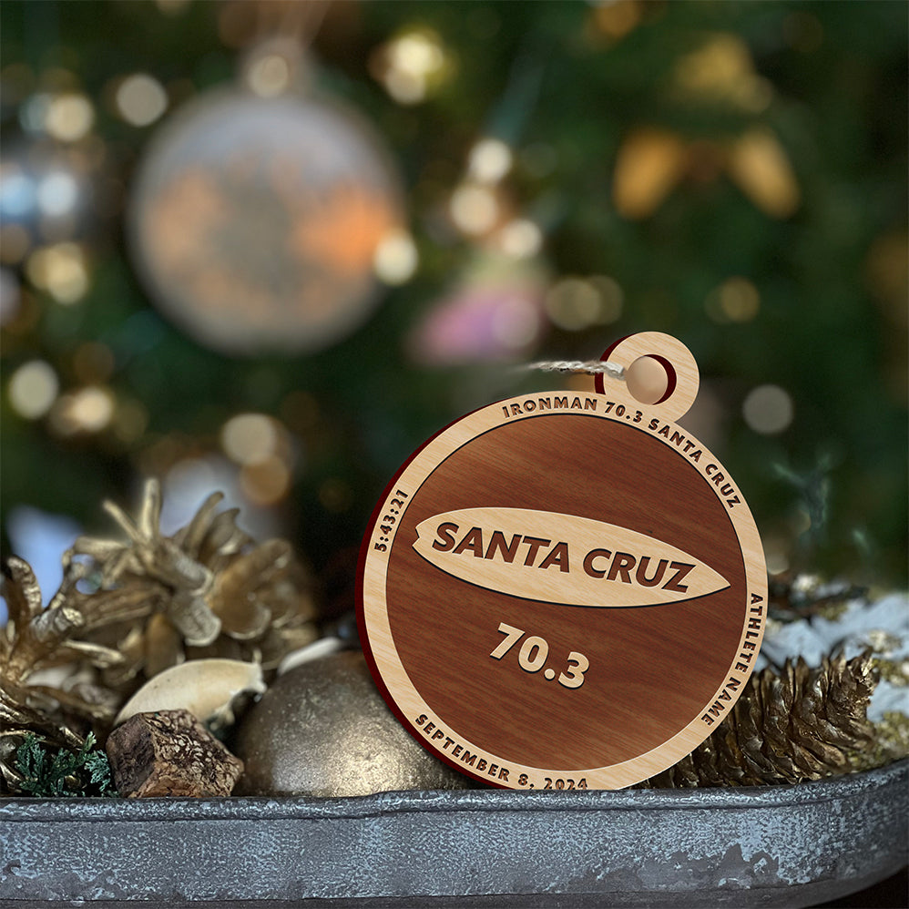 Ironman Santa Cruz Christmas ornament. The ornament is laser engraved and personalized with the athletes name and finish time.